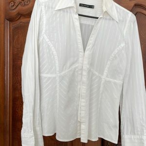 A white cotton blouse size large with many snaps for the Closure